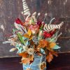 vaso di latta con fiori secchi e frutta disidratata