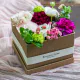 scatola beige con fiori freschi colorati